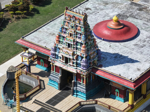Aerial view of the colorful Sri Siva Subramaniya Swami Temple with its ornate gopuram, surrounding grounds, and traditional architecture in Nadi, Western Division, Fiji.