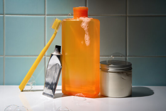 Skincare Products with a Toothbrush in a Bathroom with Tiled Blue Wall