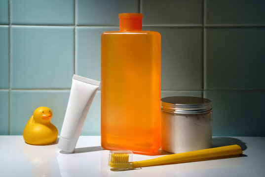 Skincare Products with a Rubber Duck in Bathroom with Tiled Blue Wall