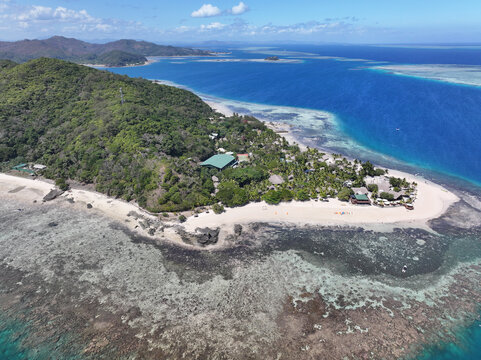 Aerial view of Castaway Island surrounded by turquoise waters, coral reefs, and lush tropical vegetation in Western Division, Fiji.