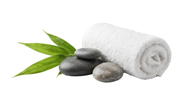 Spa set with rolled white towel, black stones, and green as isolated PNG