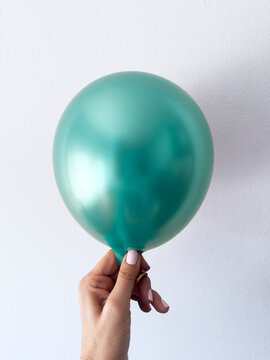 Tiffany blue color of the year balloon in hand
