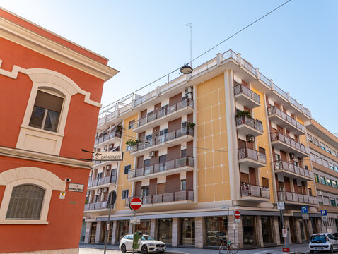 Bari, Italy - June 31, 2026: Carabinieri station sign on street corner in Bari with residential apartment building and orange historic facade visible in background