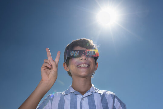 Boy Wearing Solar Eclipse Glasses Under the Sun