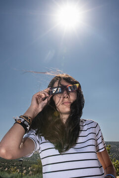 Girl Wearing Protective Glasses for a Solar Eclipse Under Bright Sunlight