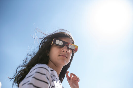 Girl Wearing Protective Glasses for a Solar Eclipse Under Bright Sunlight