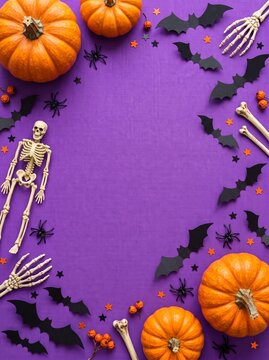 Festive halloween background frame featuring orange pumpkins black paper bats and skeleton decorations on a purple textured surface