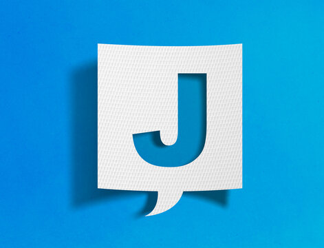 Letter J speech bubble on blue background with paper cutout design
