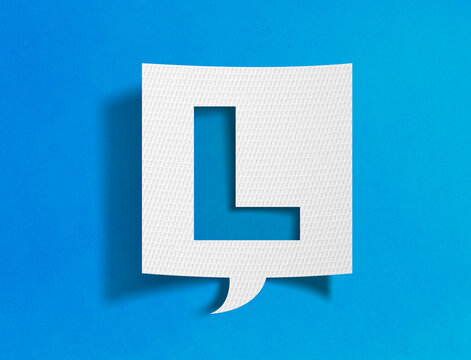 Letter L speech bubble on blue background with paper cutout design