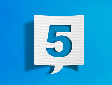 Number five speech bubble on blue background with paper cutout design