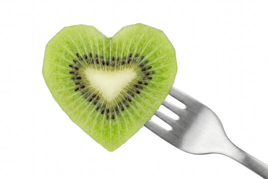 Heart shaped kiwi fruit slice on a metal fork