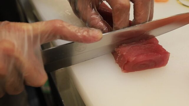 The chef prepares sushi dishes