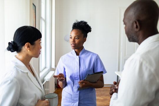 Nurse leading medical team discussion in clinic