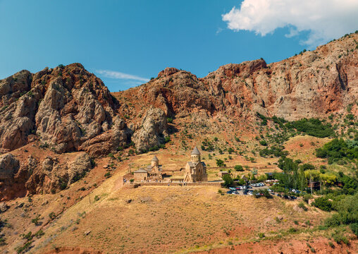 Desert Noravank monastery built against towering rocky cliffs