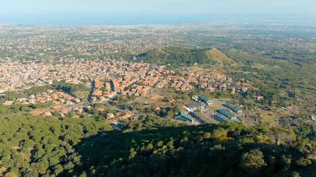 Nicolosi, Sicily, Italy. Volcanic craters overgrown with forest on the slopes of Mount Etna. Drone footage