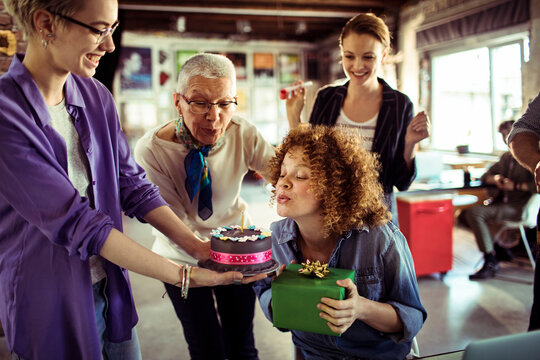 Coworkers celebrate birthday in modern office