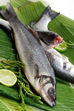 Fresh fish, loup de mer on banana leaves