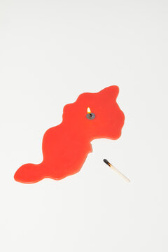A melted red candle represents burnout on a white background
