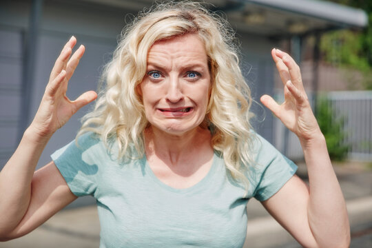 Portrait of grimacing woman outdoors