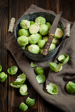 Peeled brussel sprouts in tin bucket, knife, studio