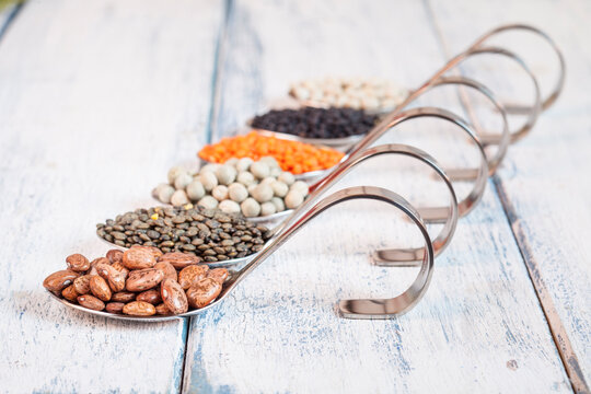 Row of spoons with different dried pulses