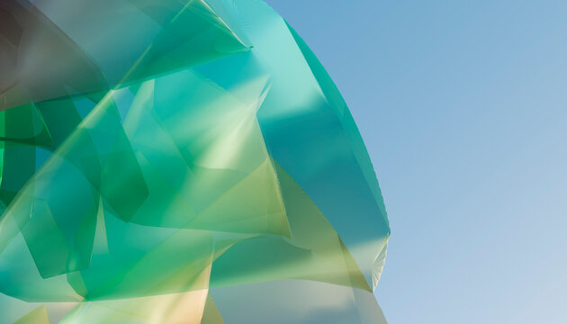 Abstract turquoise polygon structure stands against a clear blue sky
