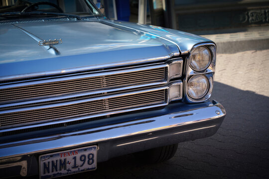 Close up front end of light blue Ford Galaxie 500 Convertible (1966) showing hood ornament, chrome grille and stacked headlights. Subotica, Serbia - July 4, 2026.