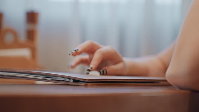 Closeup female hand typing on laptop, warm home office light, striped blackandwhite nails, steady rhythm across keys, shallow depth of field, calm productivity mood, content editing and planning