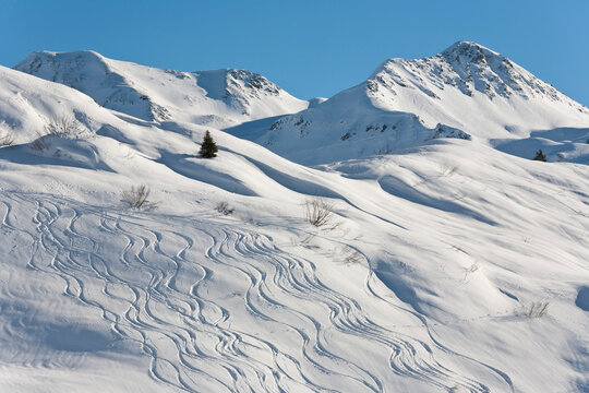 Austria, Vorarlberg, View of ski tracks on snowy mountain