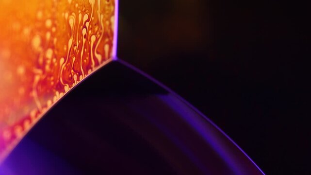 Luminous orange fluid plane with organic cellular marbling and violet edge arc. A low-key macro perspective capturing a glowing orange and gold liquid plane. Dark copy space 