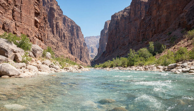 Clear flowing river through deep rocky canyon gorge with landscape mountain formation daylight wilderness adventure environment panoramic sunlight national tranquil