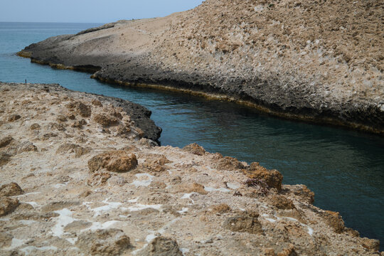 Rocky coastal inlet with turquoise water on Milos Island, Cyclades, Greece, summer travel concept, Greek islands, turquoise crystal clear water of the Aegean Sea with white rocks, summer vacation conc