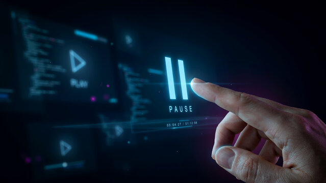 Finger touching pause button on digital screen. User interacting with media player interface.