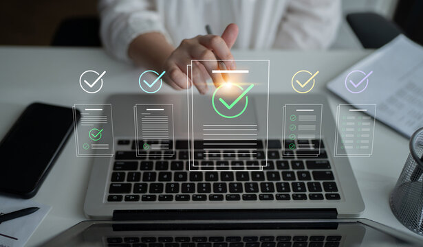 A professional person interacts with a laptop in a modern workspace, showcasing digital checkmark icons that symbolize task completion and business success. Cyphers