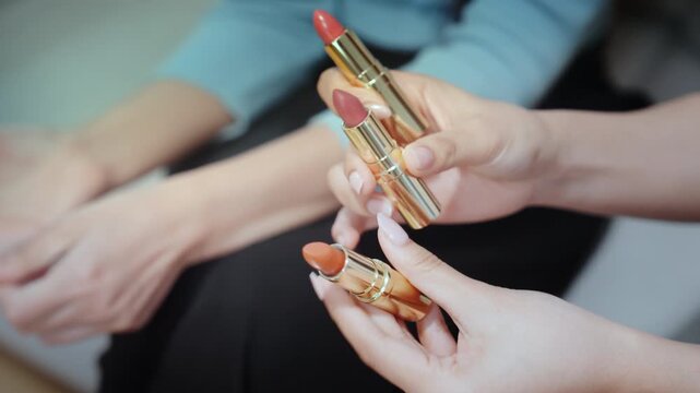 Lipstick swatch hand makeup beauty bloggers influencers live streaming tutorial capture close up testing creamy nude red coral brown shades with manicure in soft light, engaging guide product review
