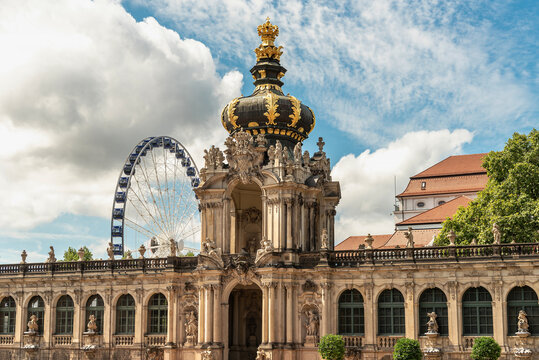 The iconic Crown Gate of the Zwinger palace with a ferris wheel in the background in Dresden, Germany