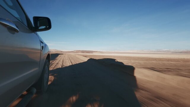 Offroad SUV / Pick Up Truck driving through Campo de Piedra Pomez in Catamarca Argentina. Front Wheel detail POV, sunrise.