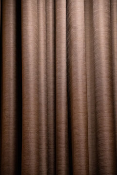 Brown Fabric Curtain Texture Background with Vertical Folds
