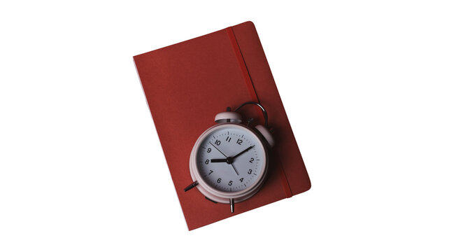 Retro mint green alarm clock placed on a red notebook with notebook stationery planning schedule deadline management isolated background business organization reminder education minimalist