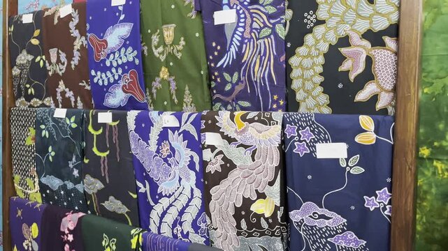 Collection of traditional Indonesian batik fabrics with colorful motifs