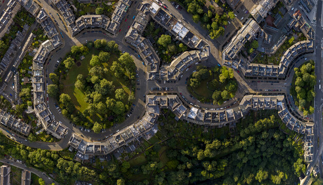 Aerial view of the historic Moray Feu featuring its distinctive circular Georgian architecture, lush central gardens, and surrounding stone townhouses in Edinburgh, Scotland, United Kingdom.