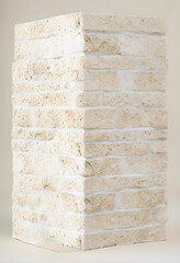 Fototapeta premium Light beige natural stone brick column with rough texture and white mortar, architectural building material, the detailed texture highlights the natural variations and craftsmanship of the stone