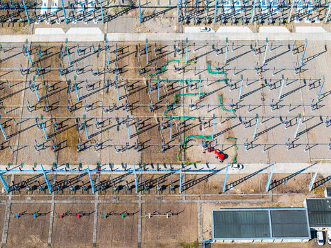 Aerial view of the electrical substation featuring rows of metal pylons, power distribution equipment, and maintenance areas in Vogelgrun, Grand Est, France.