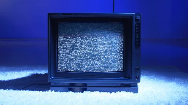 Retro TV, vintage television In a nostalgic setup, a retro TV displays grain on screen, scary halloween night device good for chroma key and green screen.