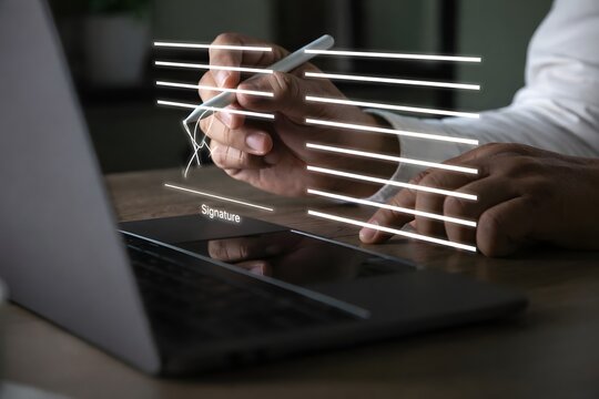 Electronic signature concept, businessman signs document on a laptop, secure e signing, document contract approval, identity verification