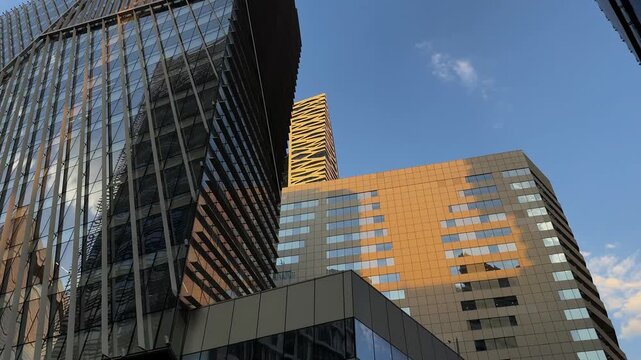 RIYADH, SAUDI ARABIA - AUGUST 7, 2026: Low Angle View Of Glass Skyscrapers Reflection In KAFD At Sunset