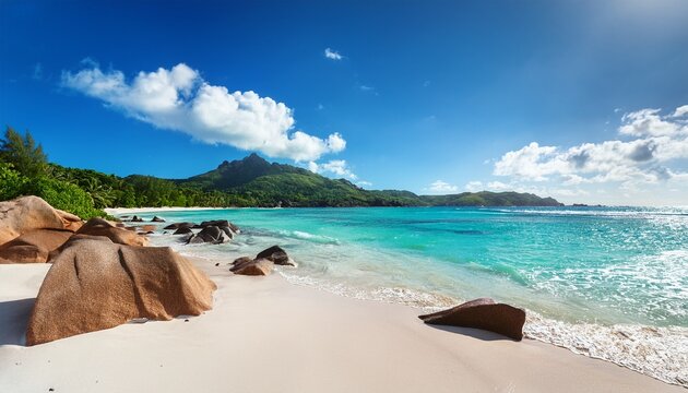 Beau Vallon Beach Seychelles Coastal Landscape With White Sand Wet Stones And Distant Coastal Mountains Under Bright Blue Sky On A Sunny Day