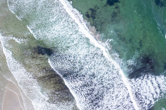 Aerial view of ocean waves breaking on shore The Concept of oceanography and nature