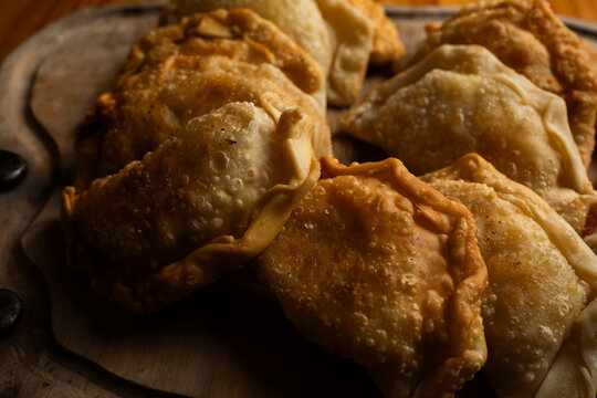 Detailed shot of traditional homemade empanadas with crispy blistered dough crust
