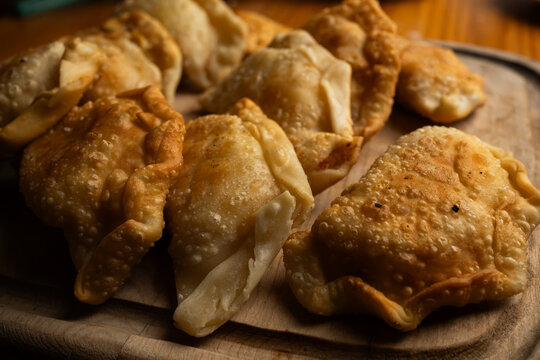 Detailed macro shot of traditional homemade empanadas with crispy blistered dough